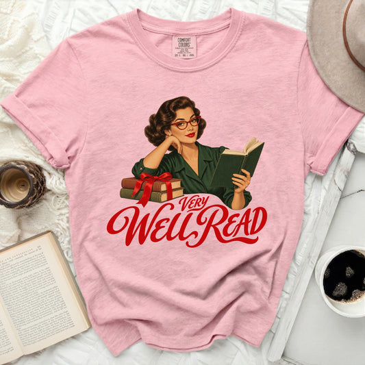 Pink t-shirt with vintage woman reading, stack of books, and "VERY Well Read" text.