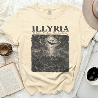 Illlyria t-shirt with an engraved scene of a city on a cliff, three birds, and mountains.