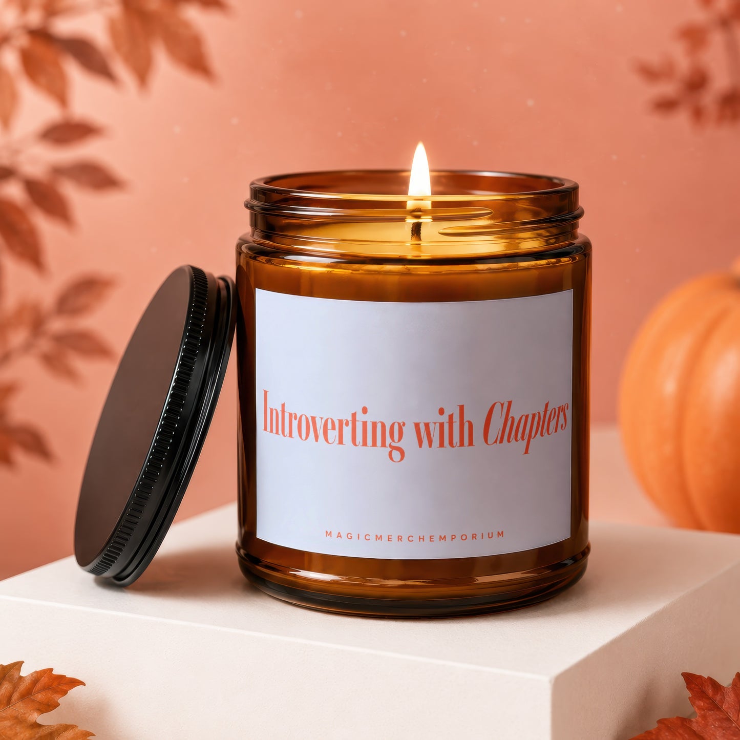 Amber candle with white label reading "Introverting with Chapters" and "MAGICMERCH)EMPORIUM".