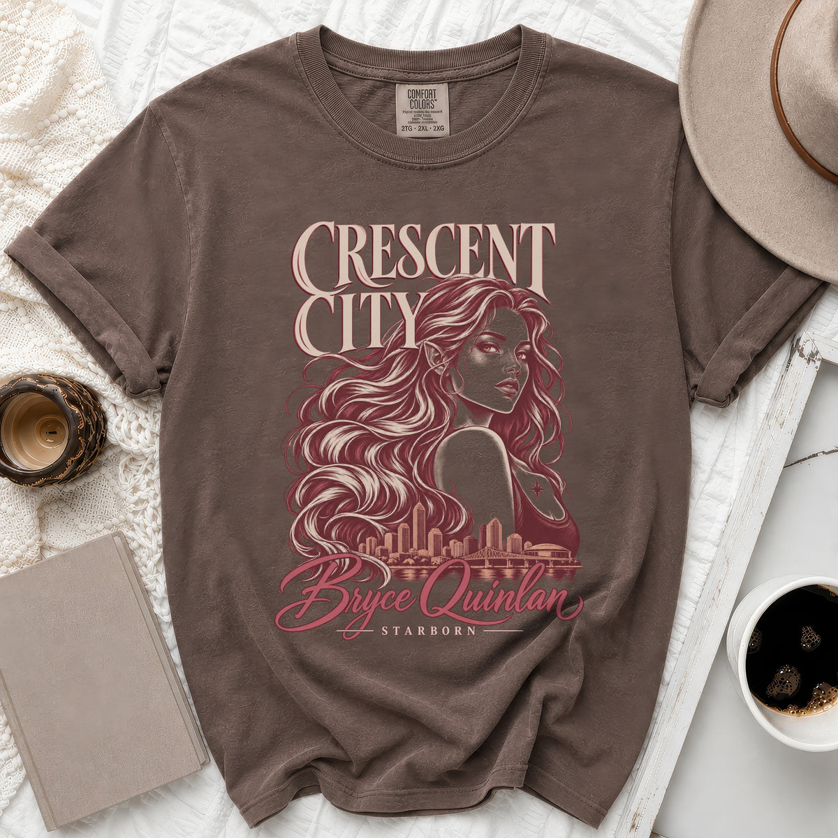Brown t-shirt with Crescent City artwork featuring Bryce Quinlan and Starborn.