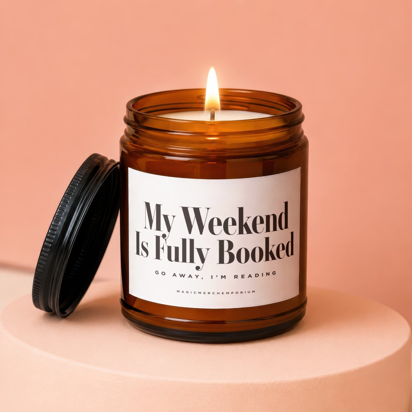 Amber jar candle with lit flame and label reading "My Weekend Is Fully Booked."