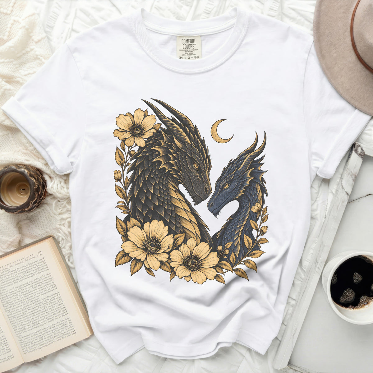 White Comfort Colors t-shirt featuring a dark and light blue dragon design with yellow flowers.
