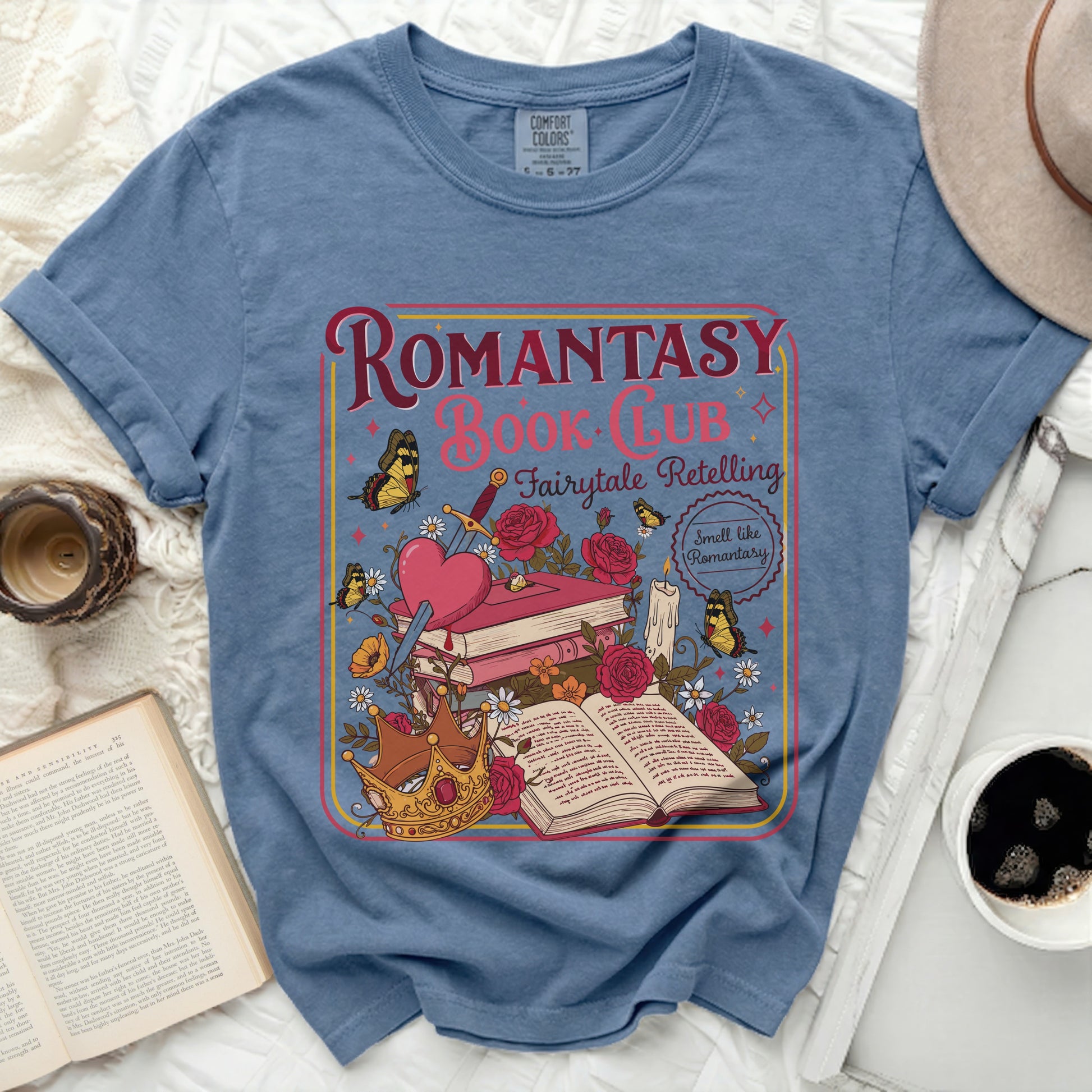 Romantasy Book Club Fairytale Retelling graphic tee on blue shirt.