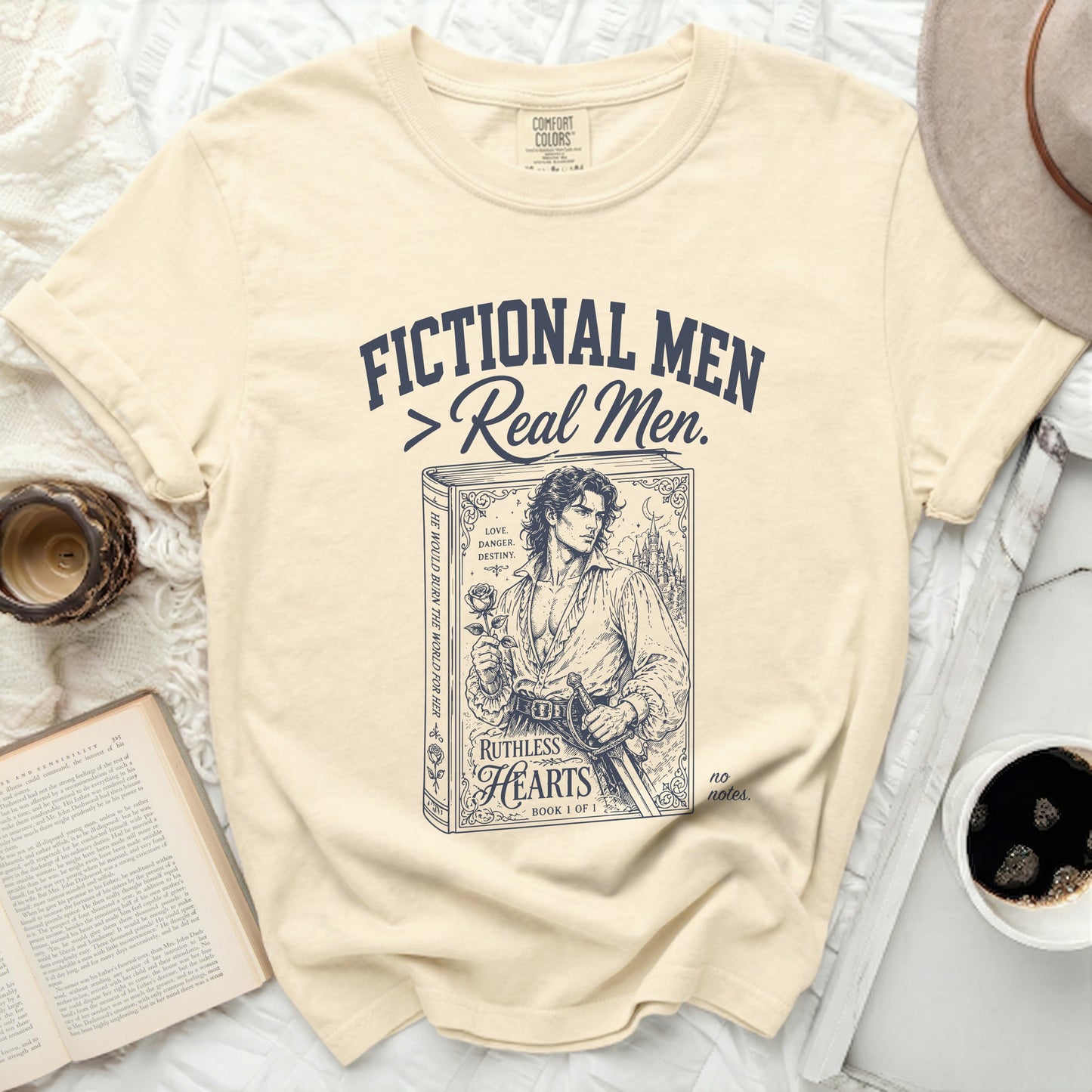 Cream t-shirt with "Fictional Men > Real Men" and a man holding a rose.