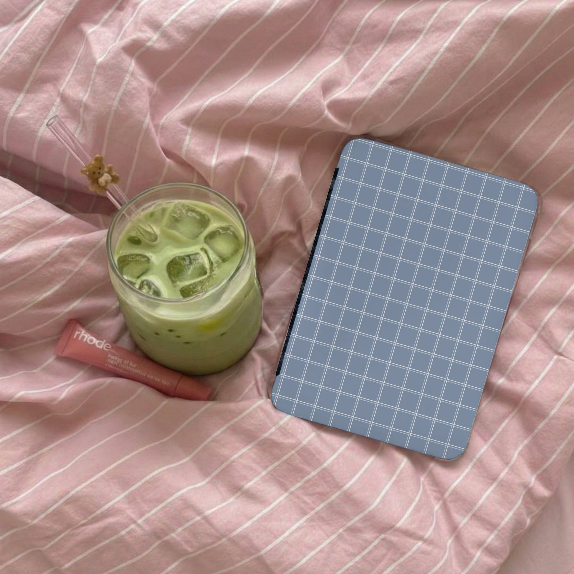 Blue Grid Patterned Notebook on Pink Striped Blanket