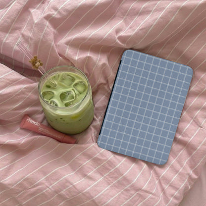 Blue Grid Patterned Notebook on Pink Striped Blanket
