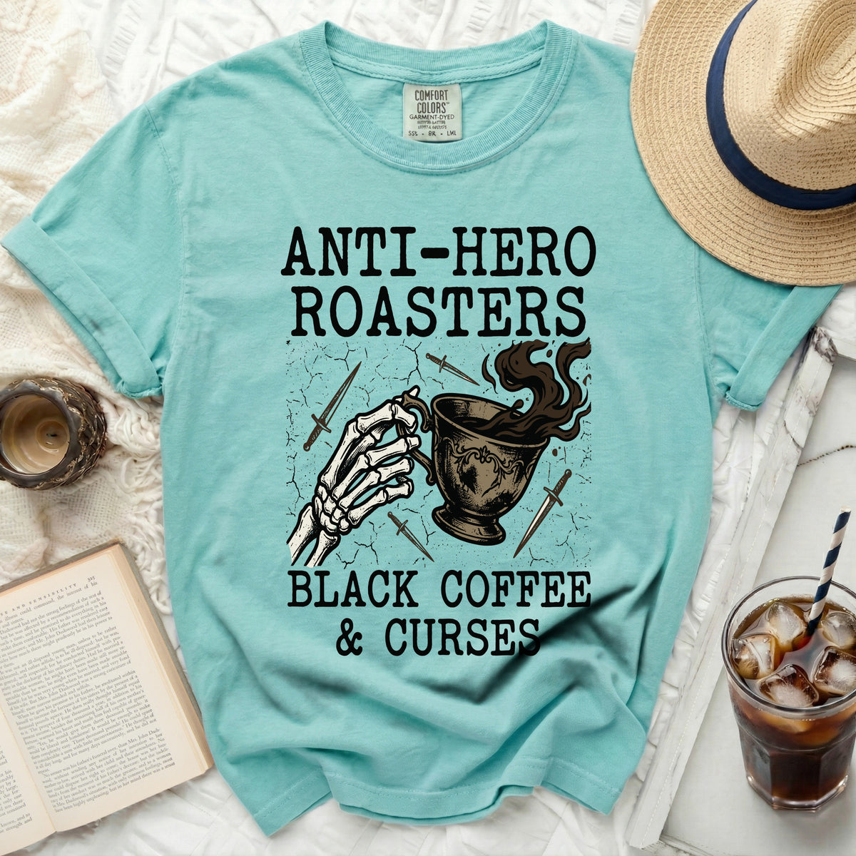 Teal t-shirt with "Anti-Hero Roasters Black Coffee & Curses" graphic.