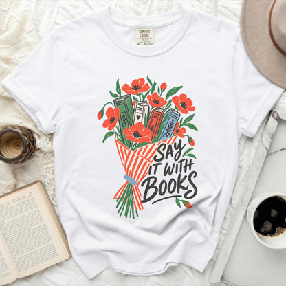 White t-shirt with a bouquet of books and poppies; text reads "Say It With Books".