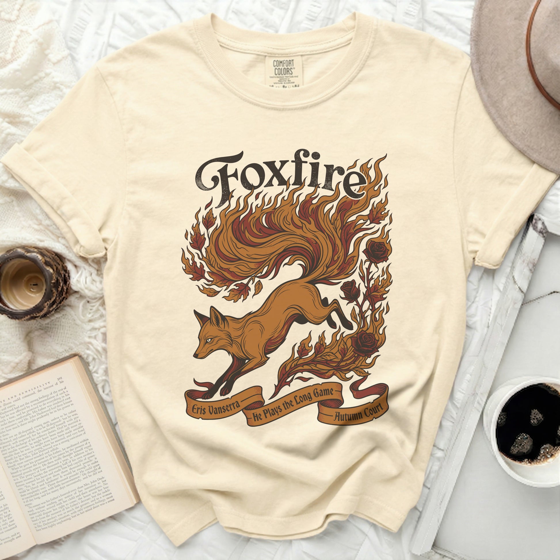 Cream t-shirt with "Foxfire" graphic, a fox, flames, roses, and text.