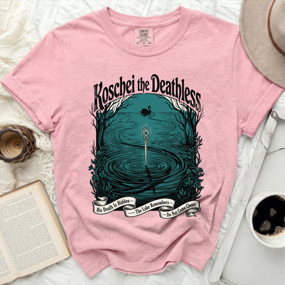 Pink t-shirt with "Koschei the Deathless" and lake imagery with text.