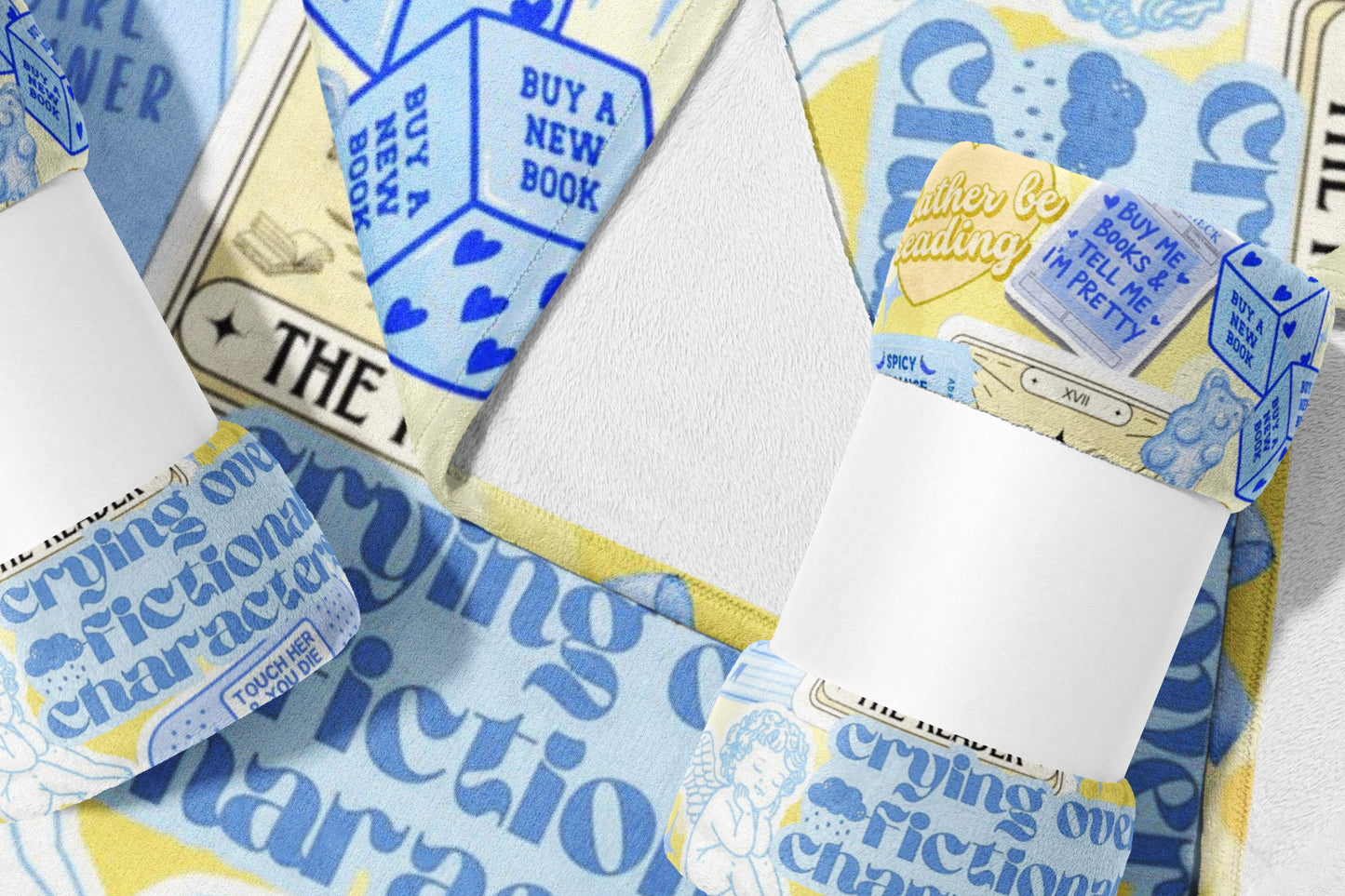 Blue and yellow towel with "crying over fictional characters" and book-themed dice.