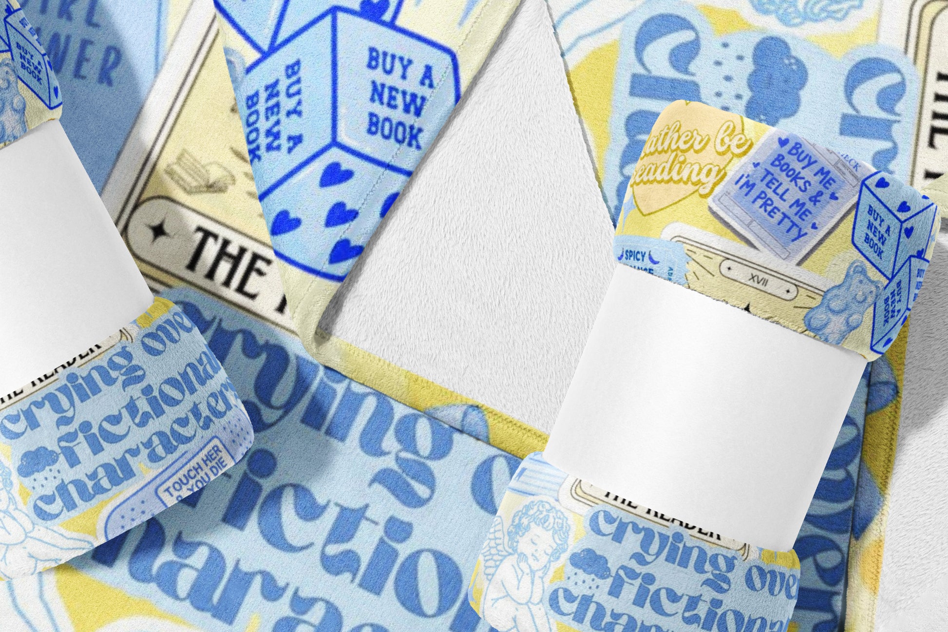 Blue and yellow towel with "crying over fictional characters" and book-themed dice.