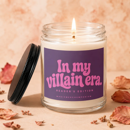 Candle with lit wick on purple label reading "In my villain era. Reader's Edition".