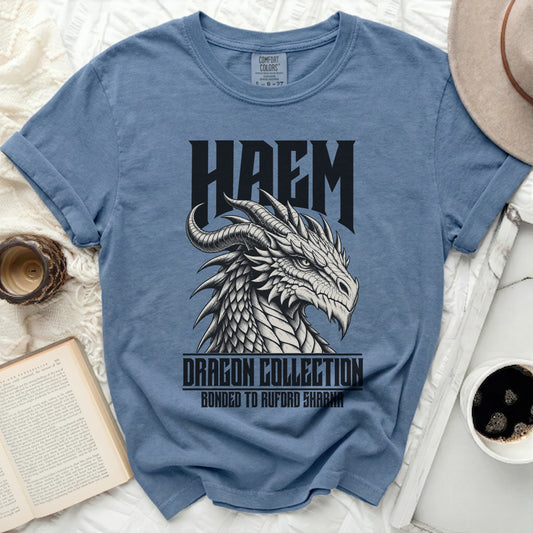 Blue t-shirt with a black and white dragon graphic and text "HAEM DRAGON COLLECTION BONDED TO RUPFORD SHARMA".