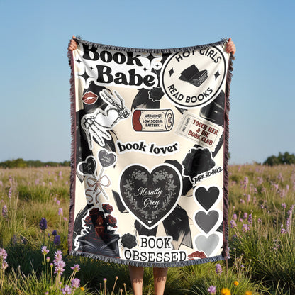 A person is holding up a blanket with various book-related designs and text, including phrases like "Book Babe", "Hot Girls Read Books", "book lover", "touch her book club", "dark romance", and "book obsessed".