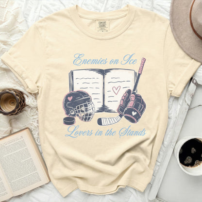 Cream t-shirt with "Enemies on Ice Lovers in the Stands" text and hockey graphics.