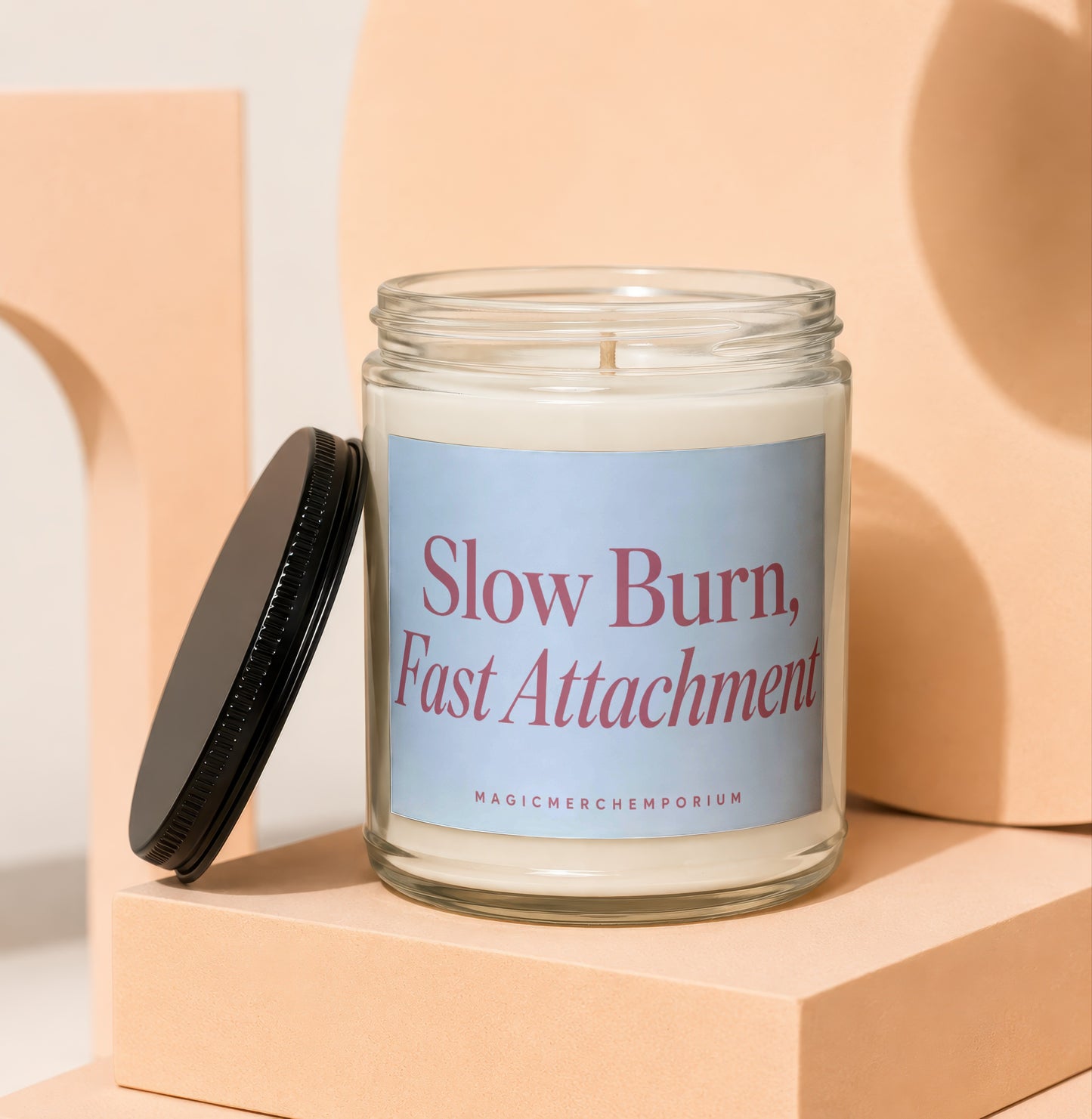 Glass candle with "Slow Burn, Fast Attachment" text and "MAGICMERCHEMPORIUM" on label.