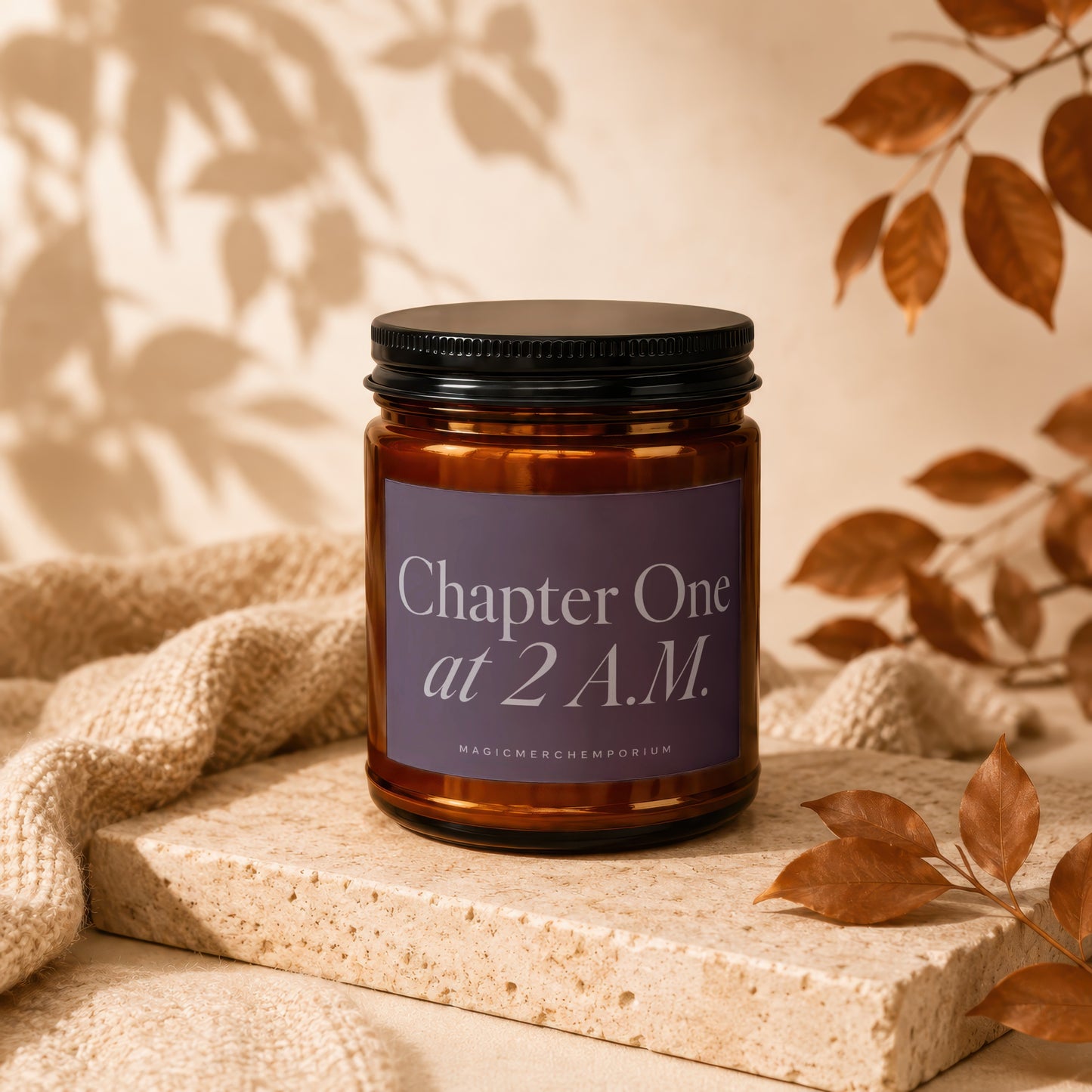 Amber glass candle with black lid, reads "Chapter One at 2 A.M."