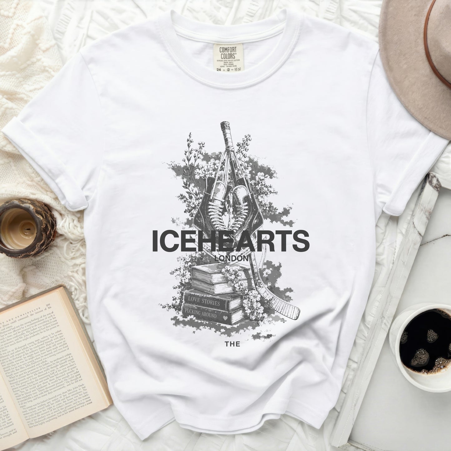 White t-shirt with "ICEHEARTS LONDON" and hockey stick and skates graphic.