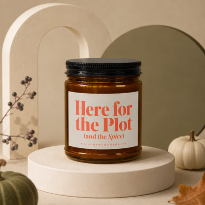 Candle with label reading "Here for the Plot (and the Spice) MAGICMERCH"}," MagicMerchEmporium".