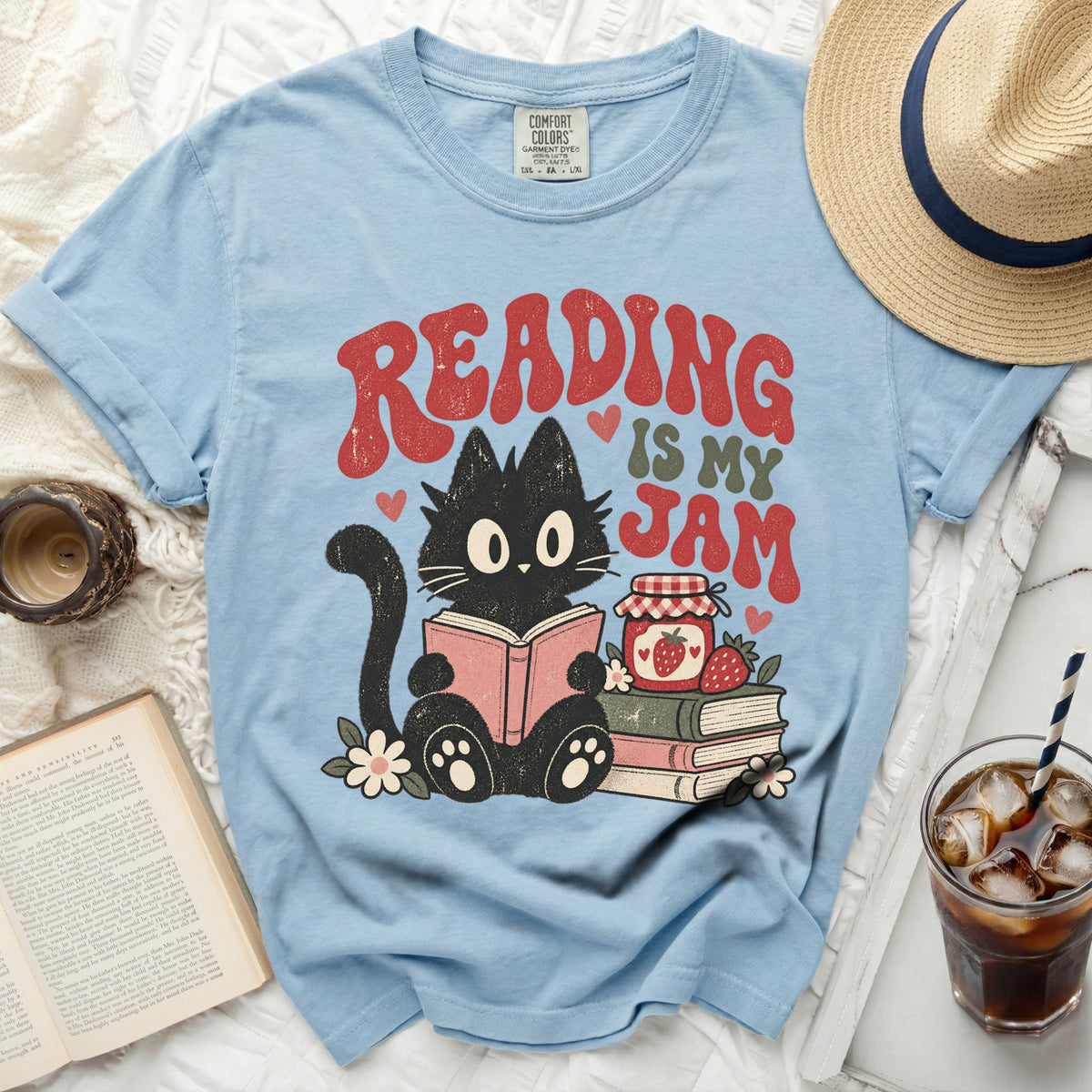 Light blue t-shirt with a black cat reading, "Reading is My Jam" text, and jam jar.