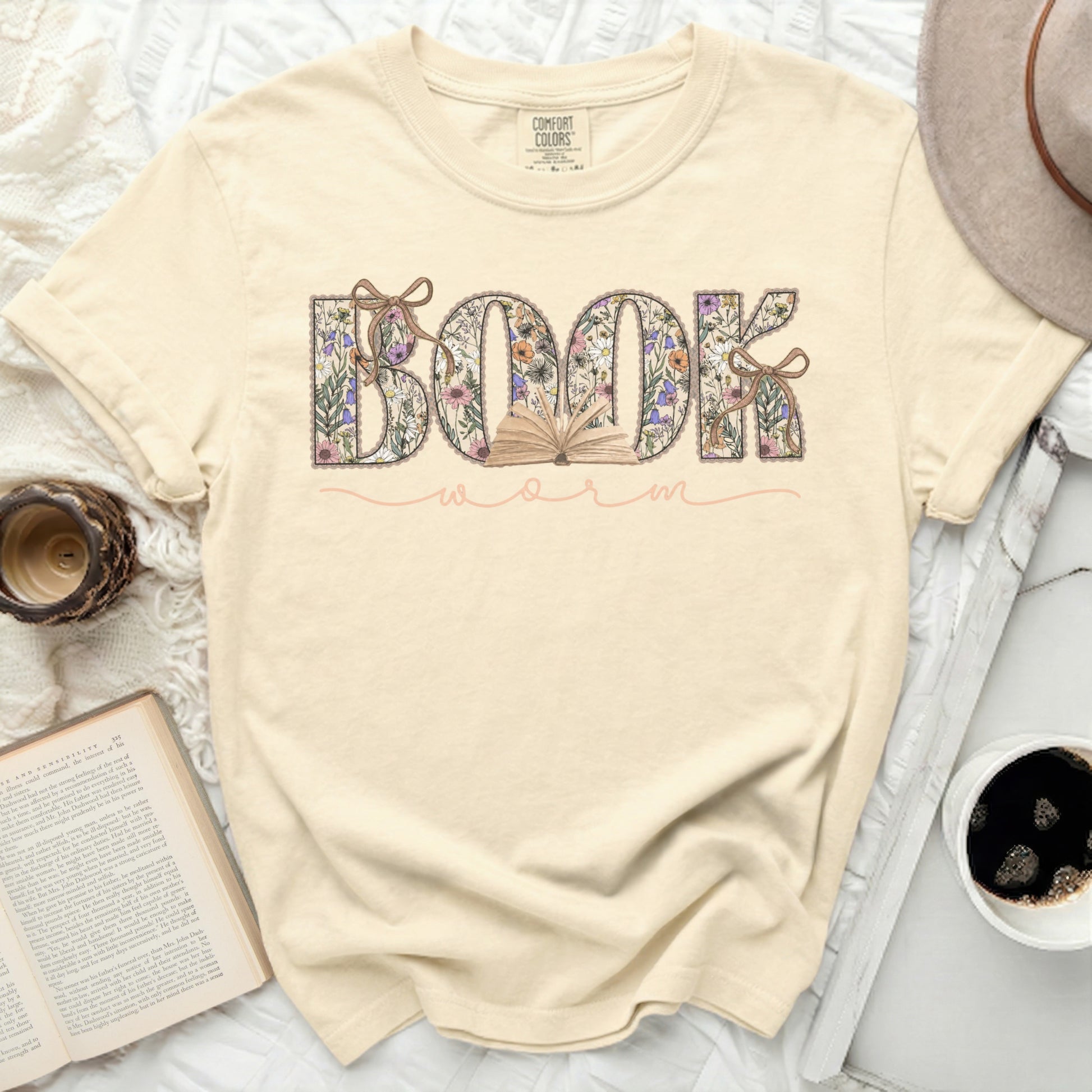 Cream t-shirt with "BOOK WORM" in floral letters and a small open book.