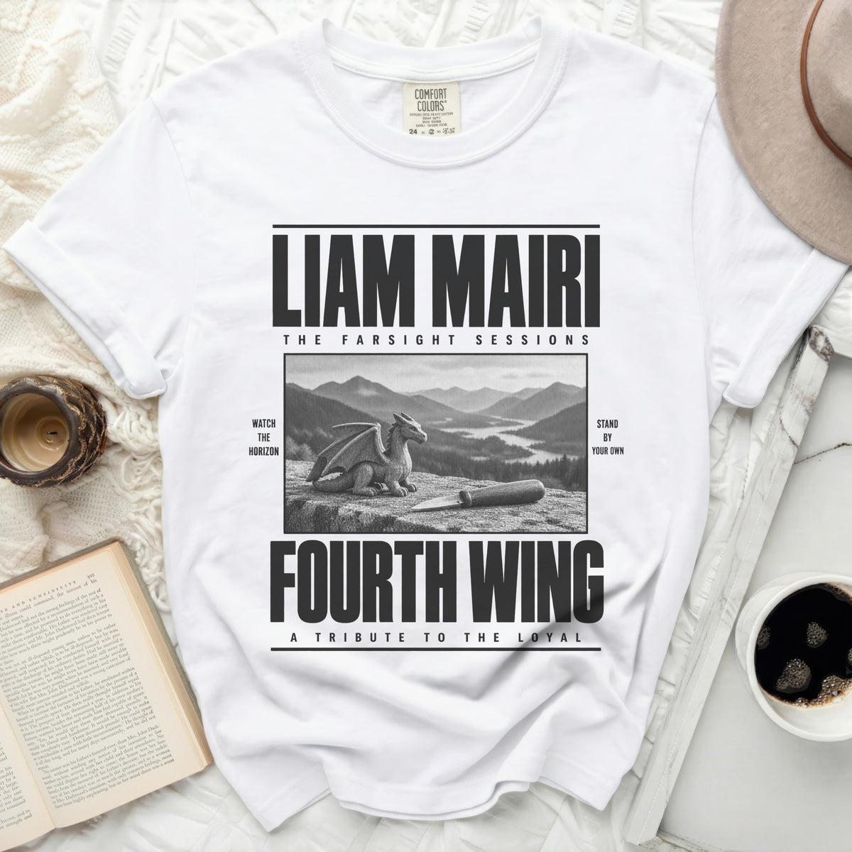 White t-shirt with Liam Mairi Fourth Wing design, dragon, mountains, and knife.