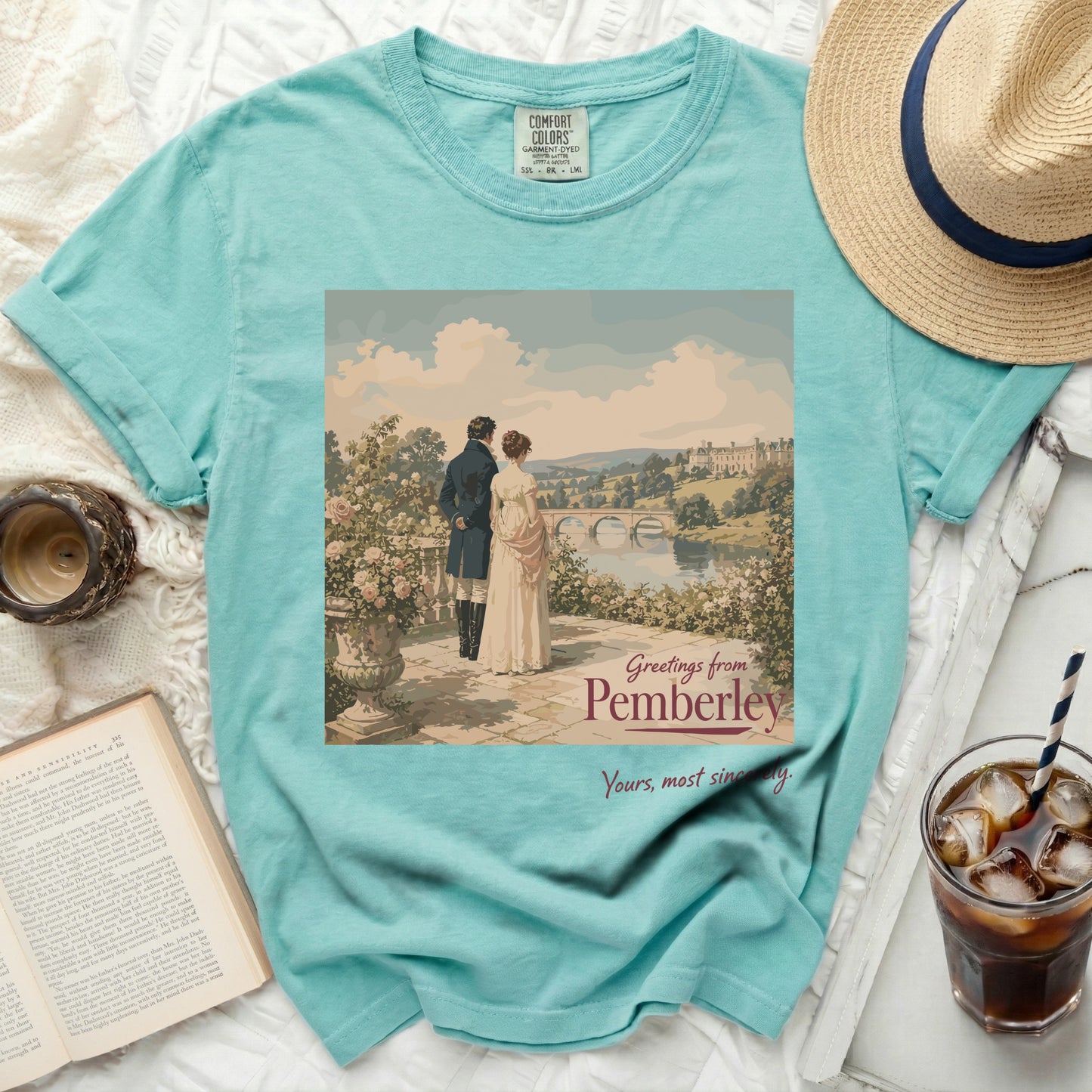 Teal t-shirt with "Greetings from Pemberley" graphic of a couple.