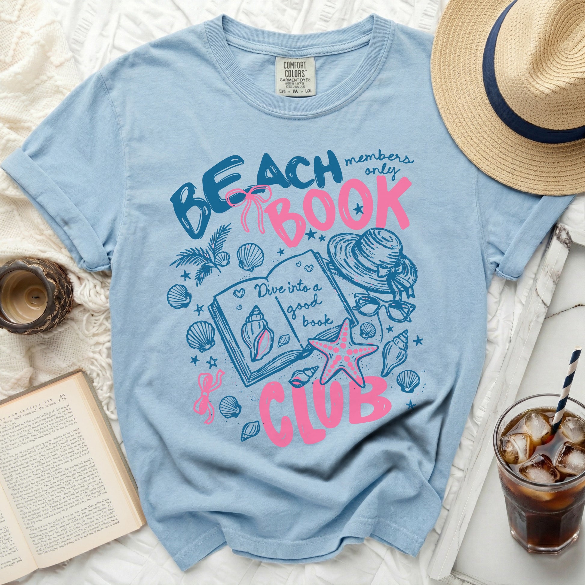 Light blue t-shirt with "Beach members only Book Club" and book illustrations.