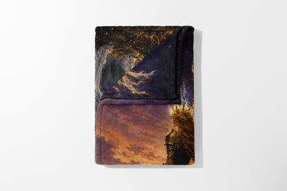 Folded blanket with artwork of a crowned warrior against a fiery sky and starry background.