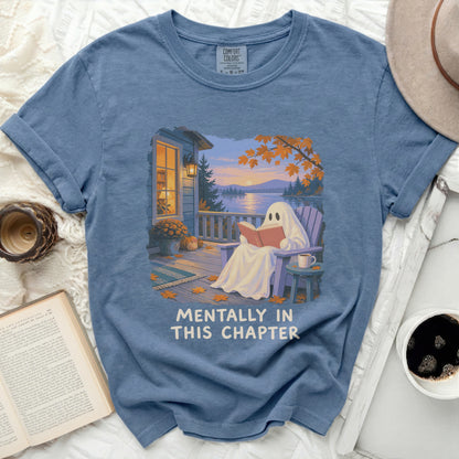 Ghost reading a book on a porch with text "MENTALLY IN THIS CHAPTER".