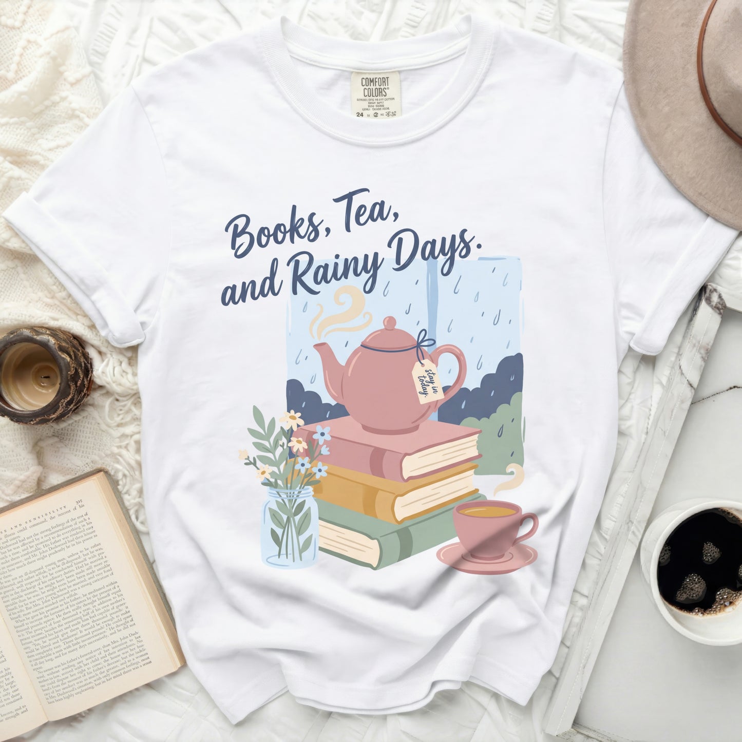 White t-shirt with "Books, Tea, and Rainy Days" text and illustration.