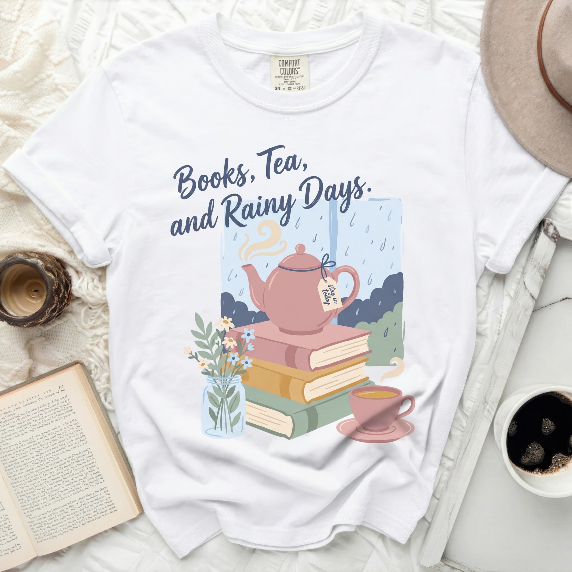 White t-shirt with "Books, Tea, and Rainy Days" text and illustration.