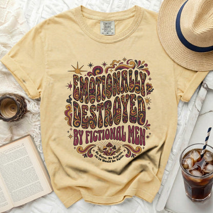 Yellow t-shirt with "Emotionally Destroyed by Fictional Men" text.