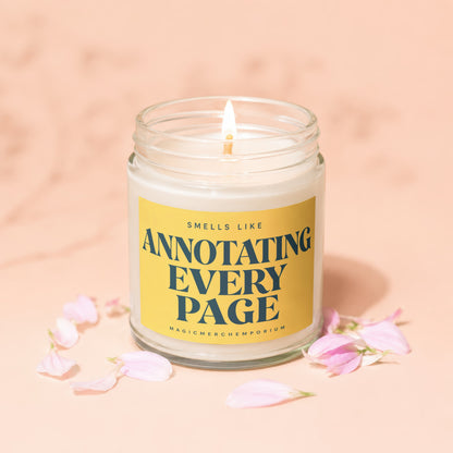 Glass candle with lit wick and yellow label reading "Smells Like Annotating Every Page".