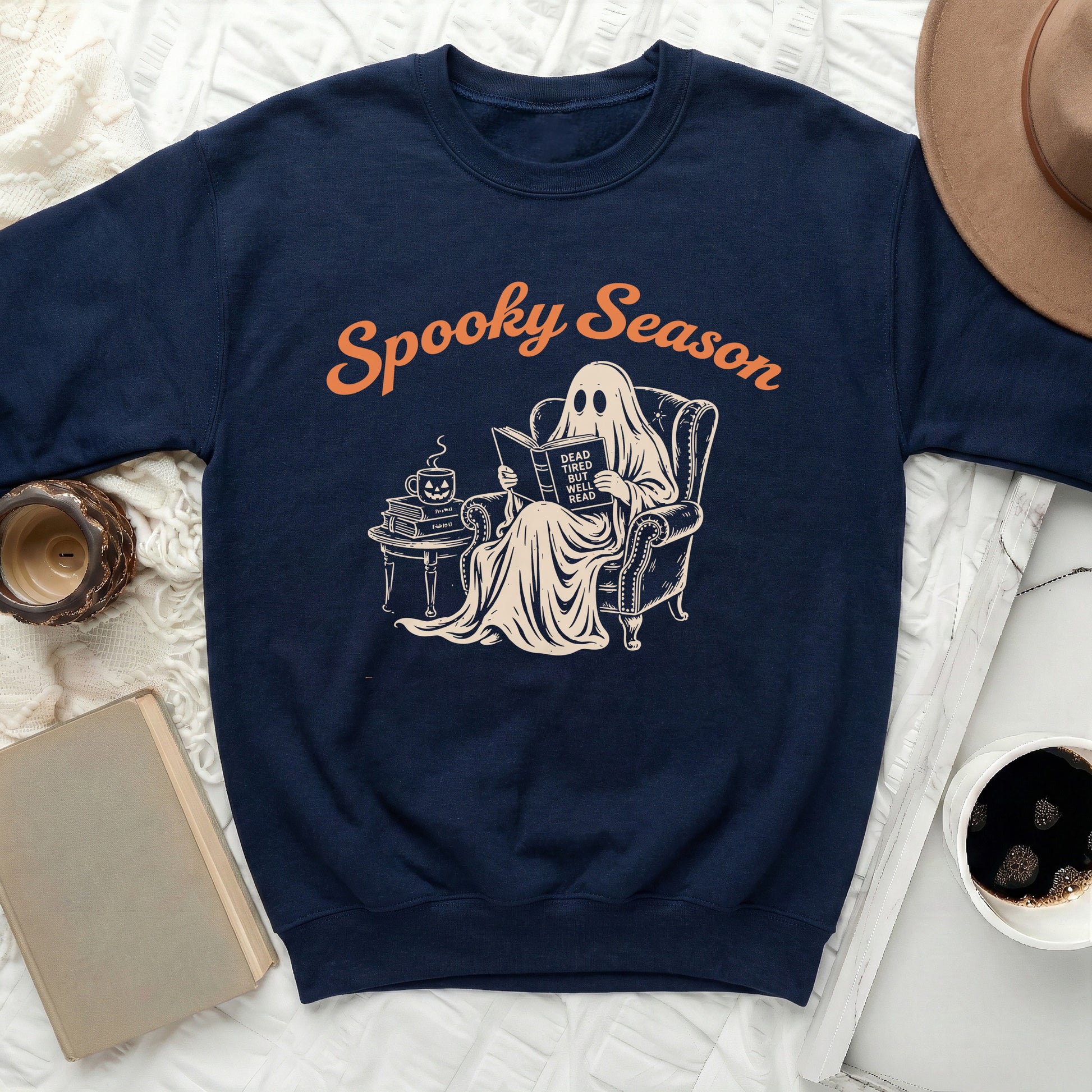 Navy sweatshirt with "Spooky Season" text and ghost reading a book graphic.
