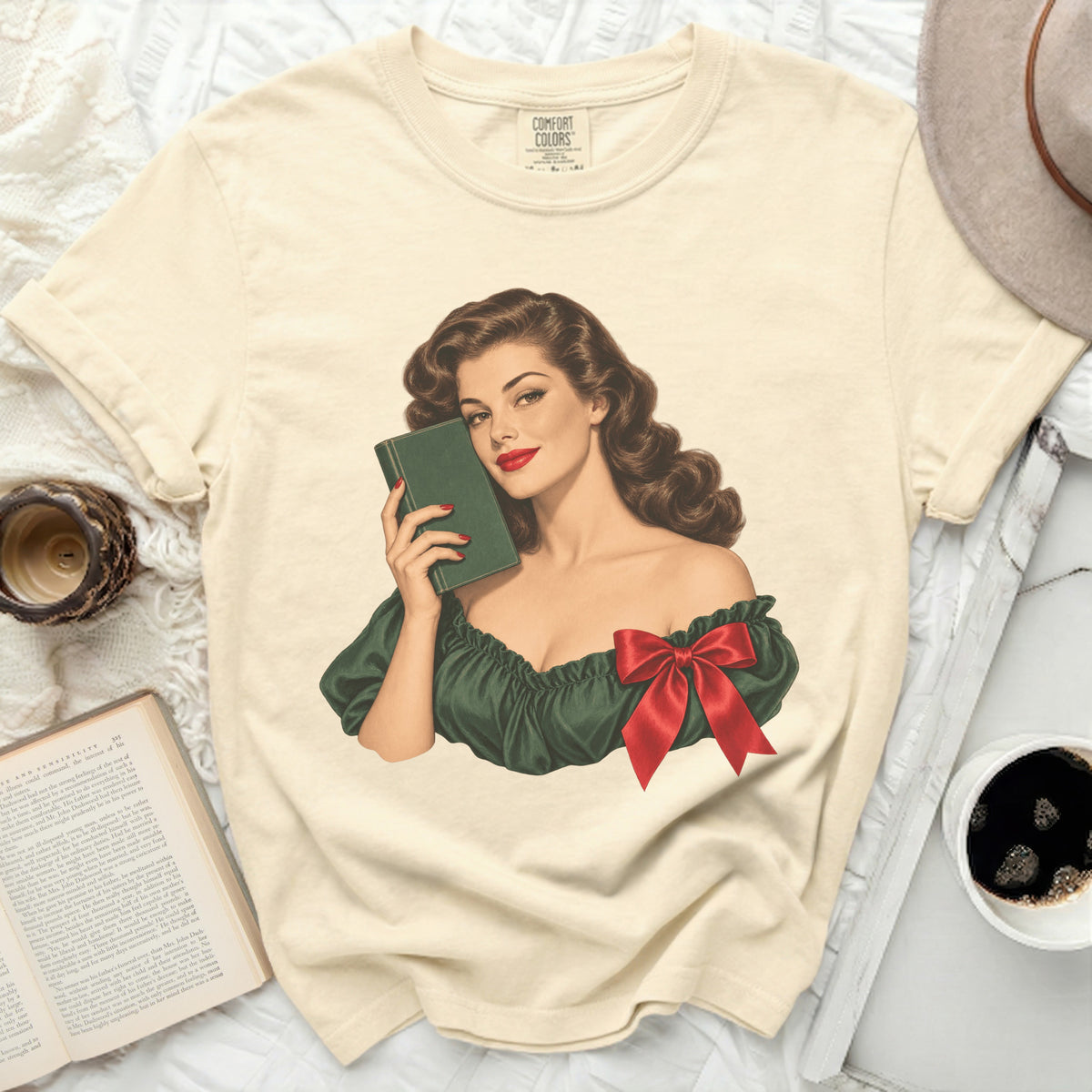 Woman in retro style holding a green book, wearing a green off-the-shoulder top with red bow.