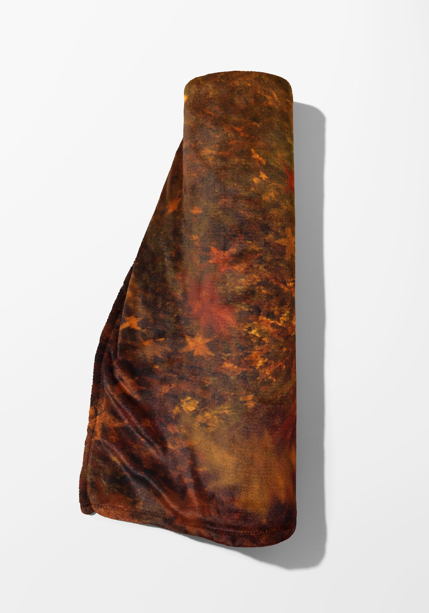 Rolled brown and orange fuzzy blanket with a star pattern.