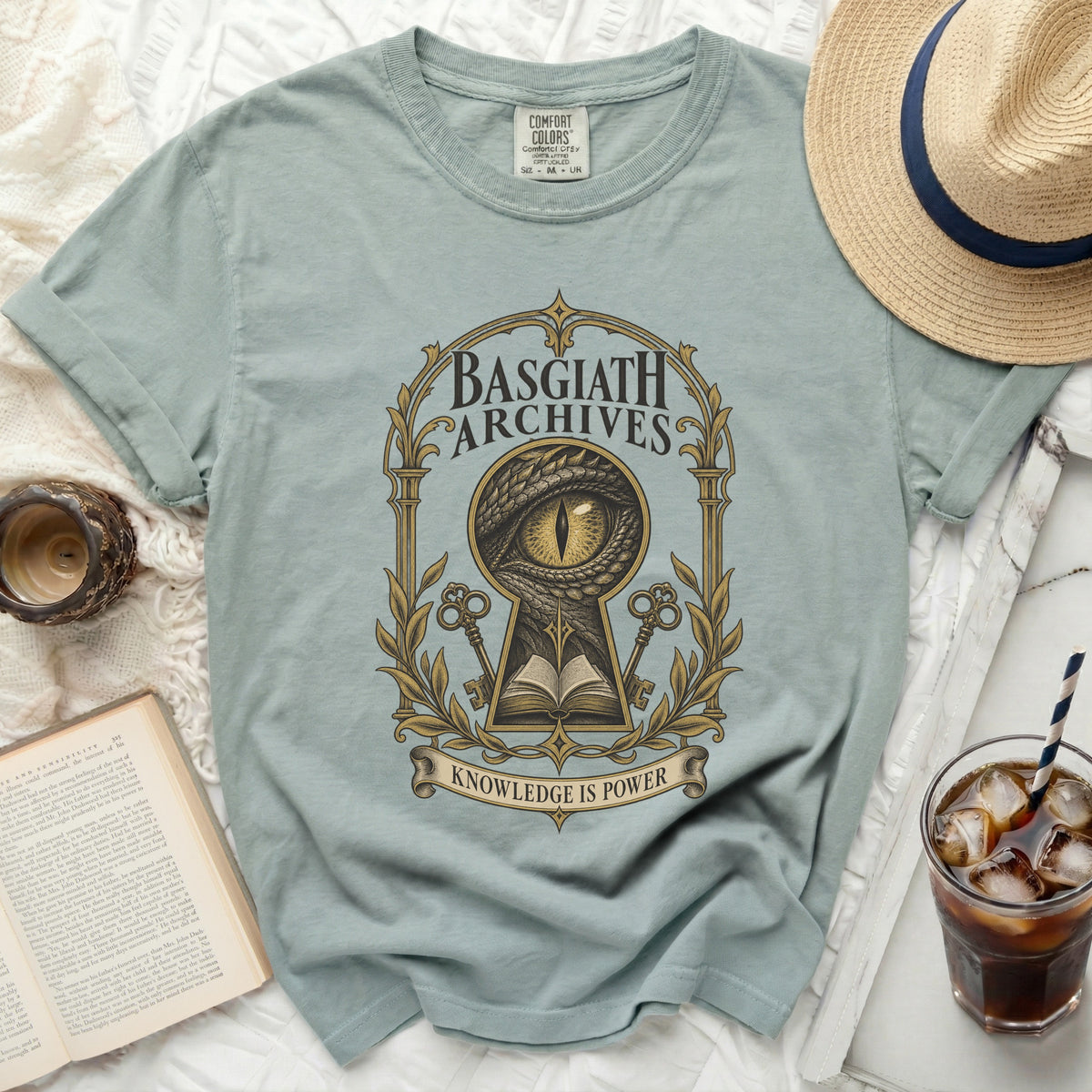 T-shirt with "Basgiath Archives" and a dragon eye design. "Knowledge is Power" text.