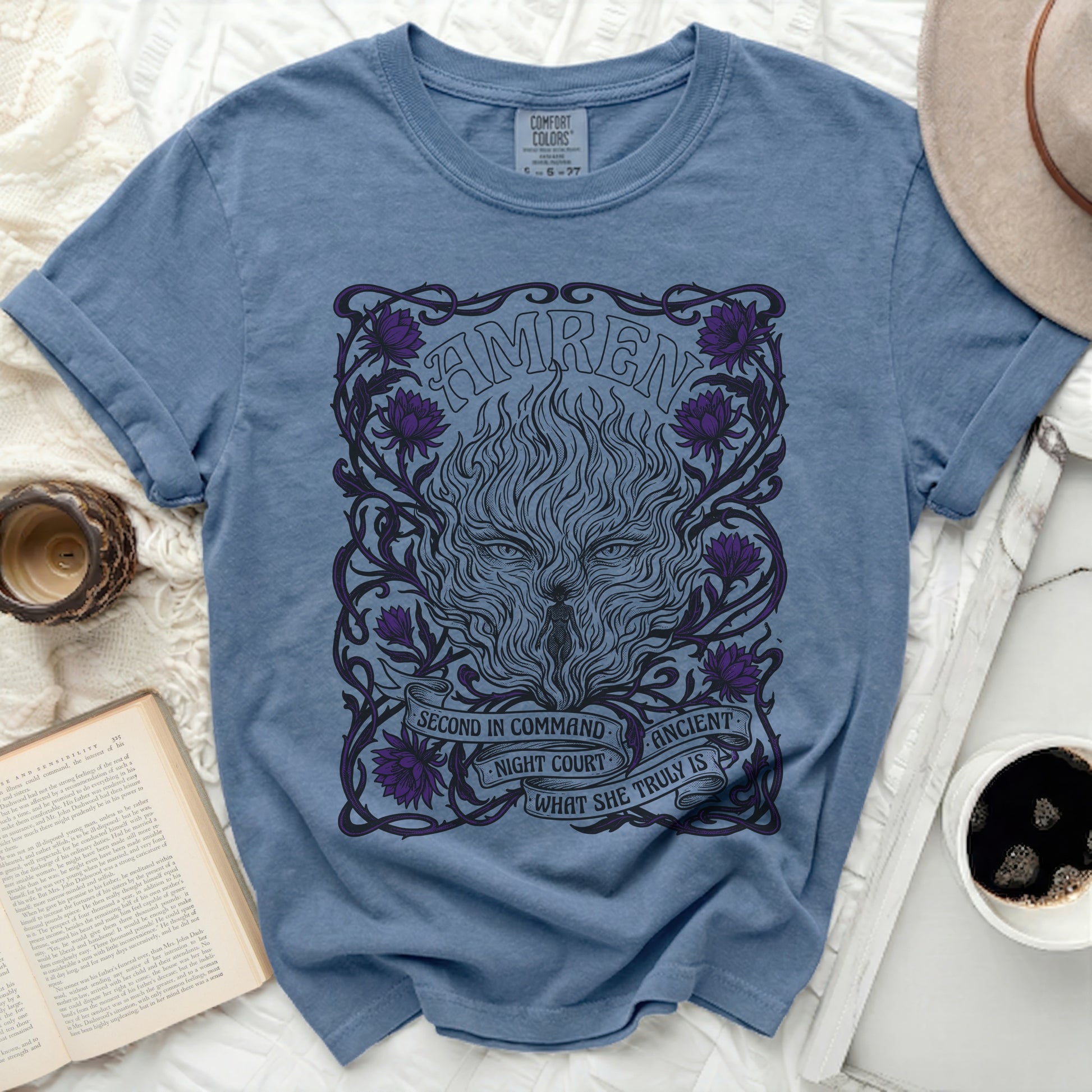 Blue t-shirt with a graphic of a wolf face, fire, and text "AMREN" and "SECOND IN COMMAND. ANCIENT NIGHT COURT WHAT SHE TRULY IS".