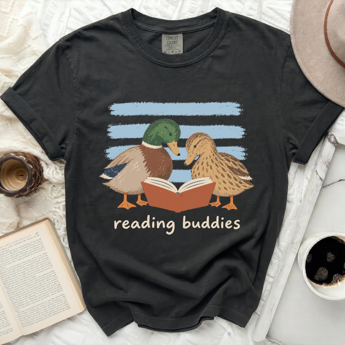Black t-shirt with two ducks reading a book and "reading buddies" text.