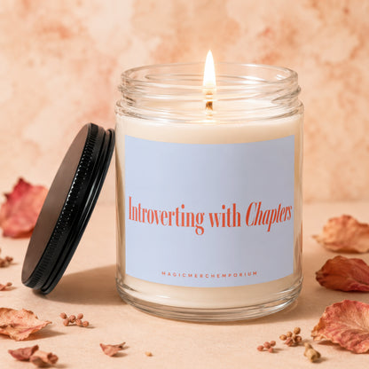 Candle with "Introverting with Chapters" text and "MAGICMERCHEMPORIUM" on label.