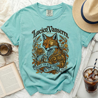 Teal t-shirt with a stylized fox design and text "Lucien Vanserra" and "Emissary Fox Boy Sunshine The Mating Bond Waits".