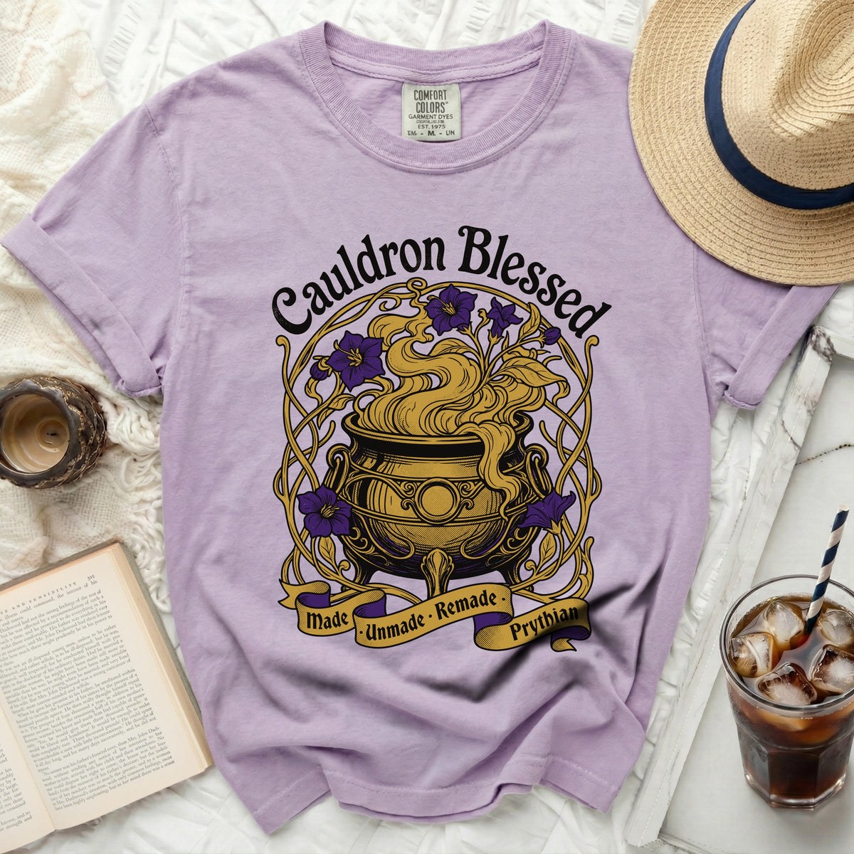 Purple t-shirt with "Cauldron Blessed" and "Made Unmade Remade Prythian" graphic.