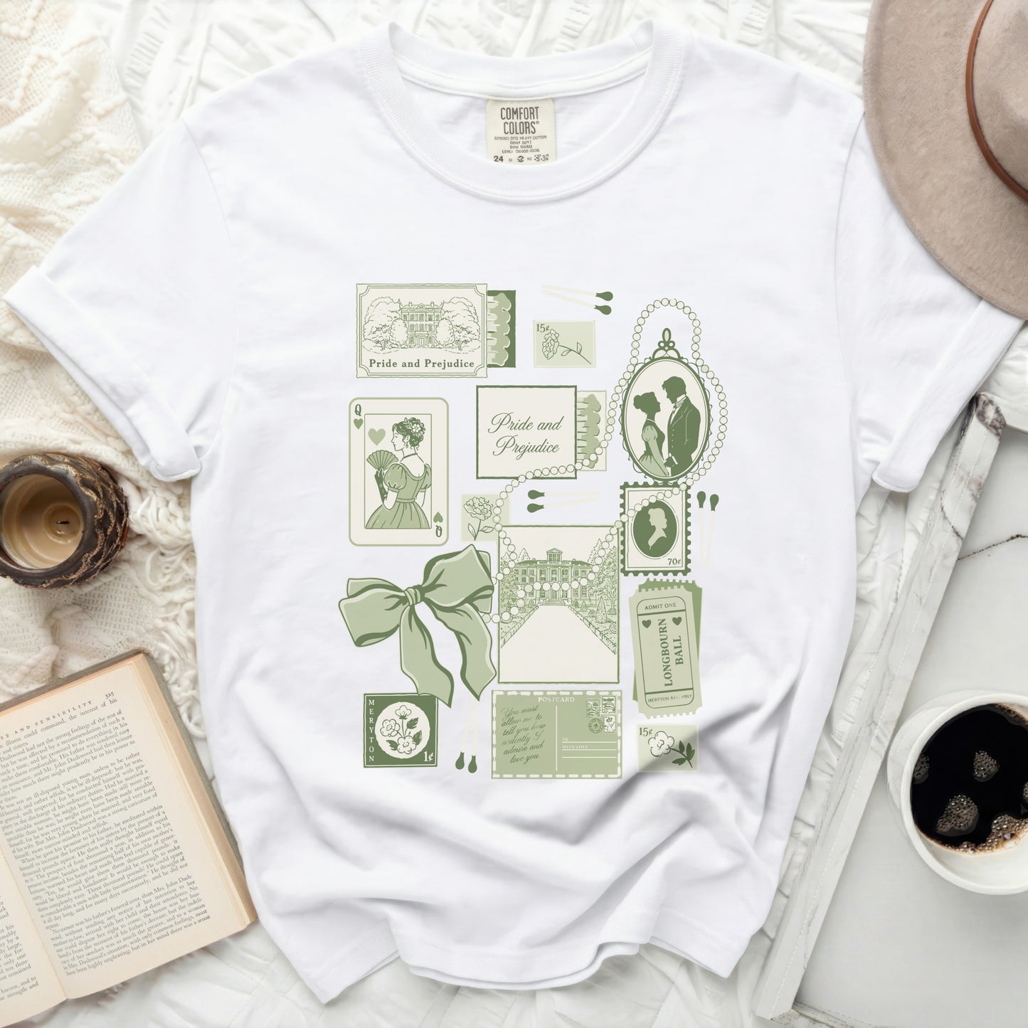 White t-shirt with "Pride and Prejudice" themed green graphic including portraits and buildings.