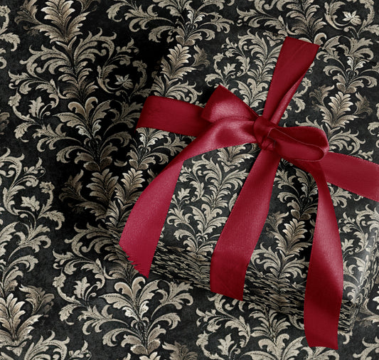 Elegant Red Ribbon Wrapped Gift Item with Dark Leaf Design
