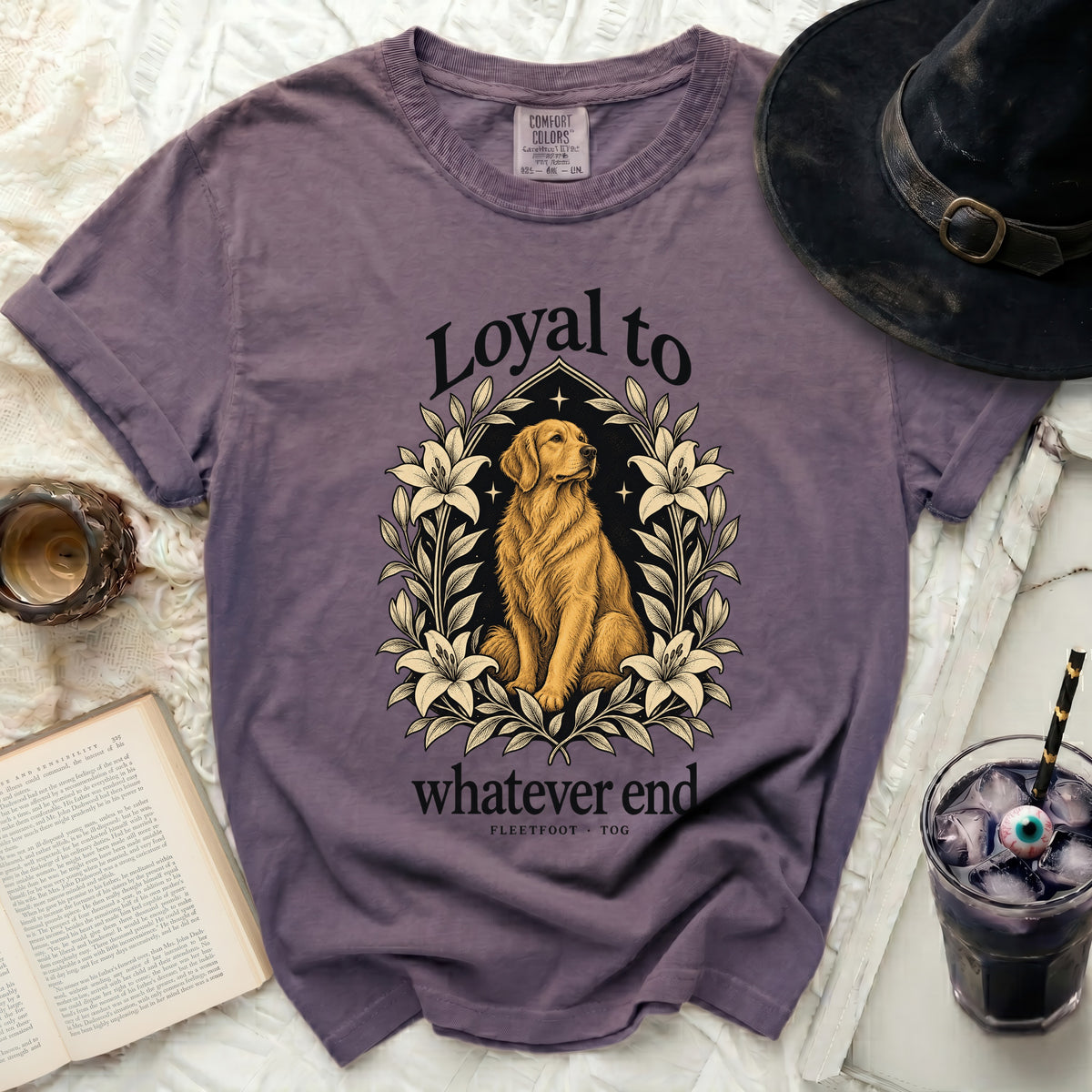 Purple t-shirt with a golden retriever surrounded by lilies and the text "Loyal to whatever end".
