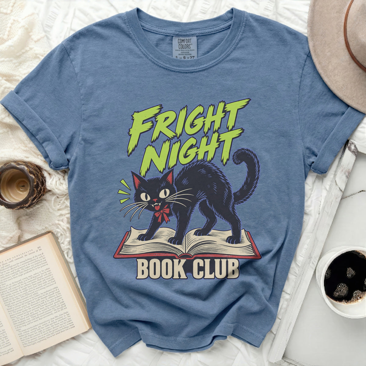 Blue t-shirt with black cat on book, text "FRIGHT NIGHT BOOK CLUB".