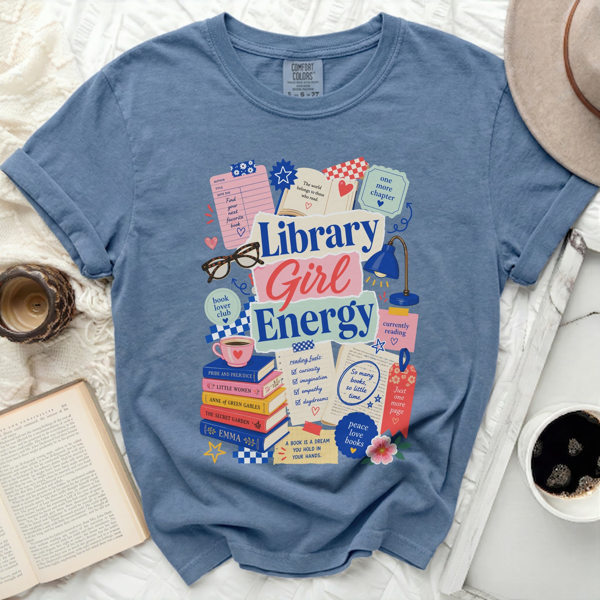 Blue t-shirt with "Library Girl Energy" and book-themed illustrations.