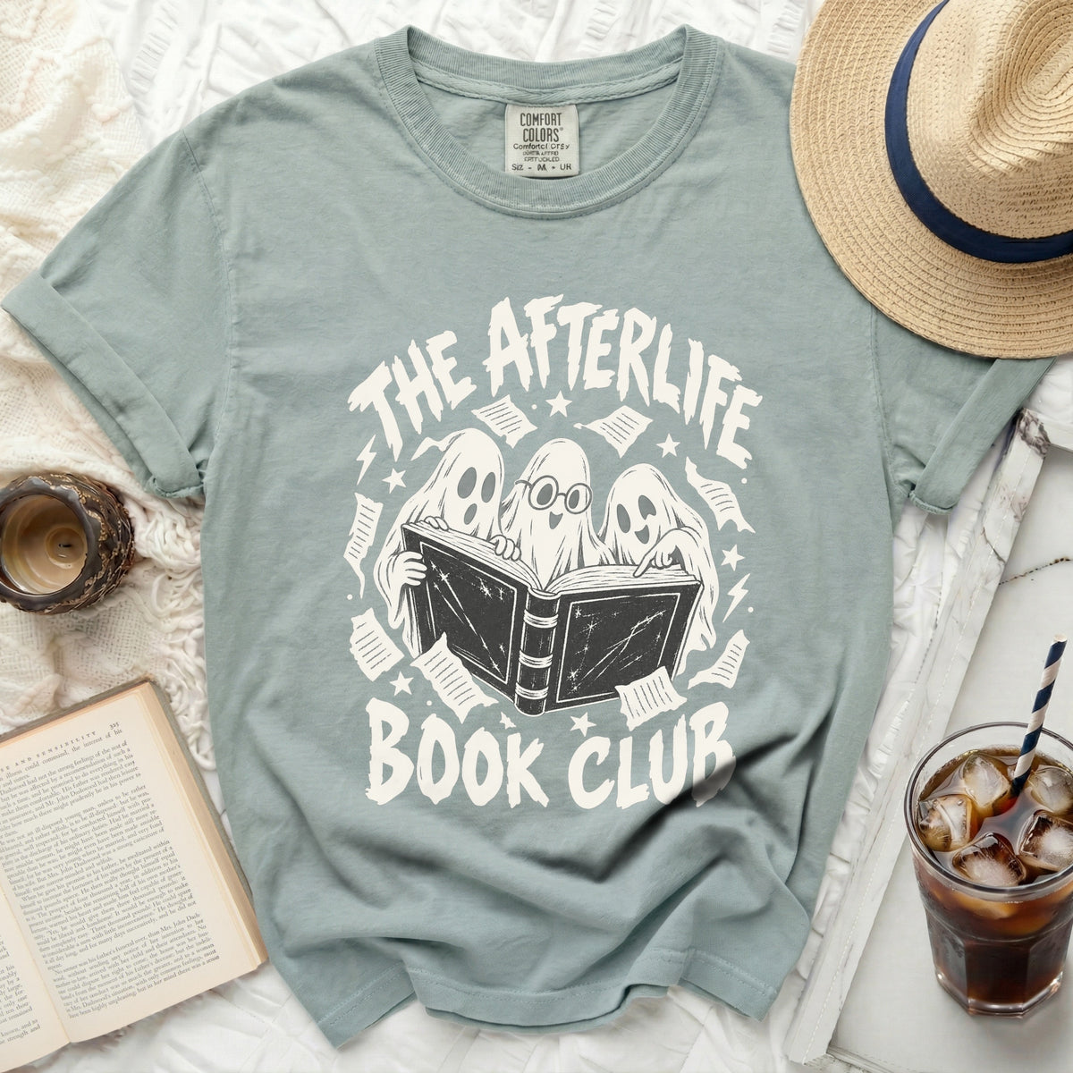 Three ghosts reading a book on a "The Afterlife Book Club" t-shirt.